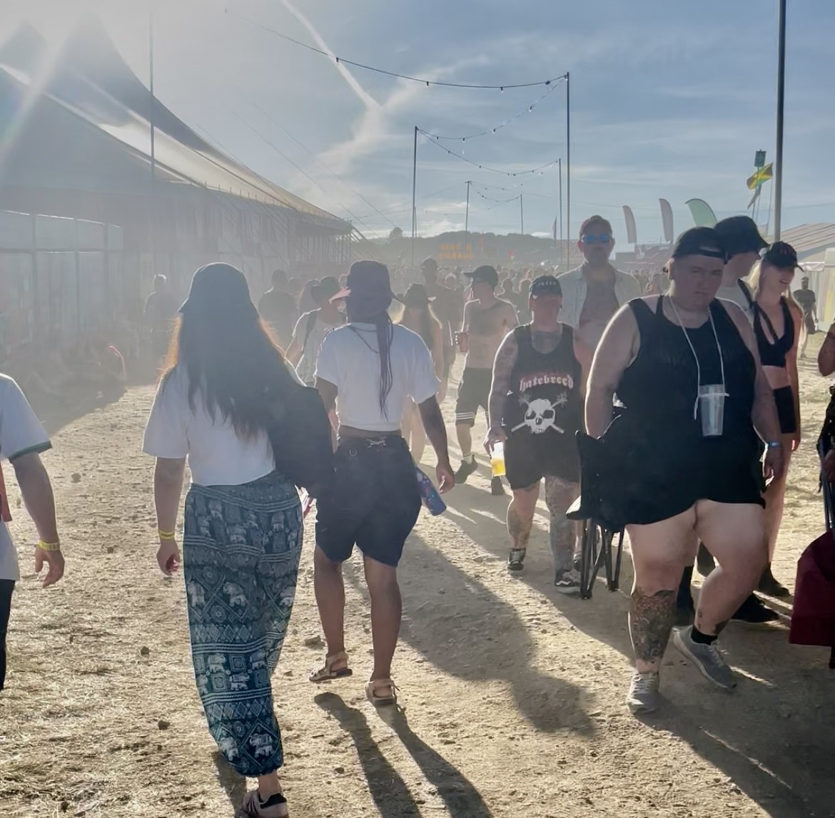Crowd of festival-goers walking through dusty grounds at 2000trees Festival 2025, capturing the energetic atmosphere and outdoor festival experience at UK summer music festivals